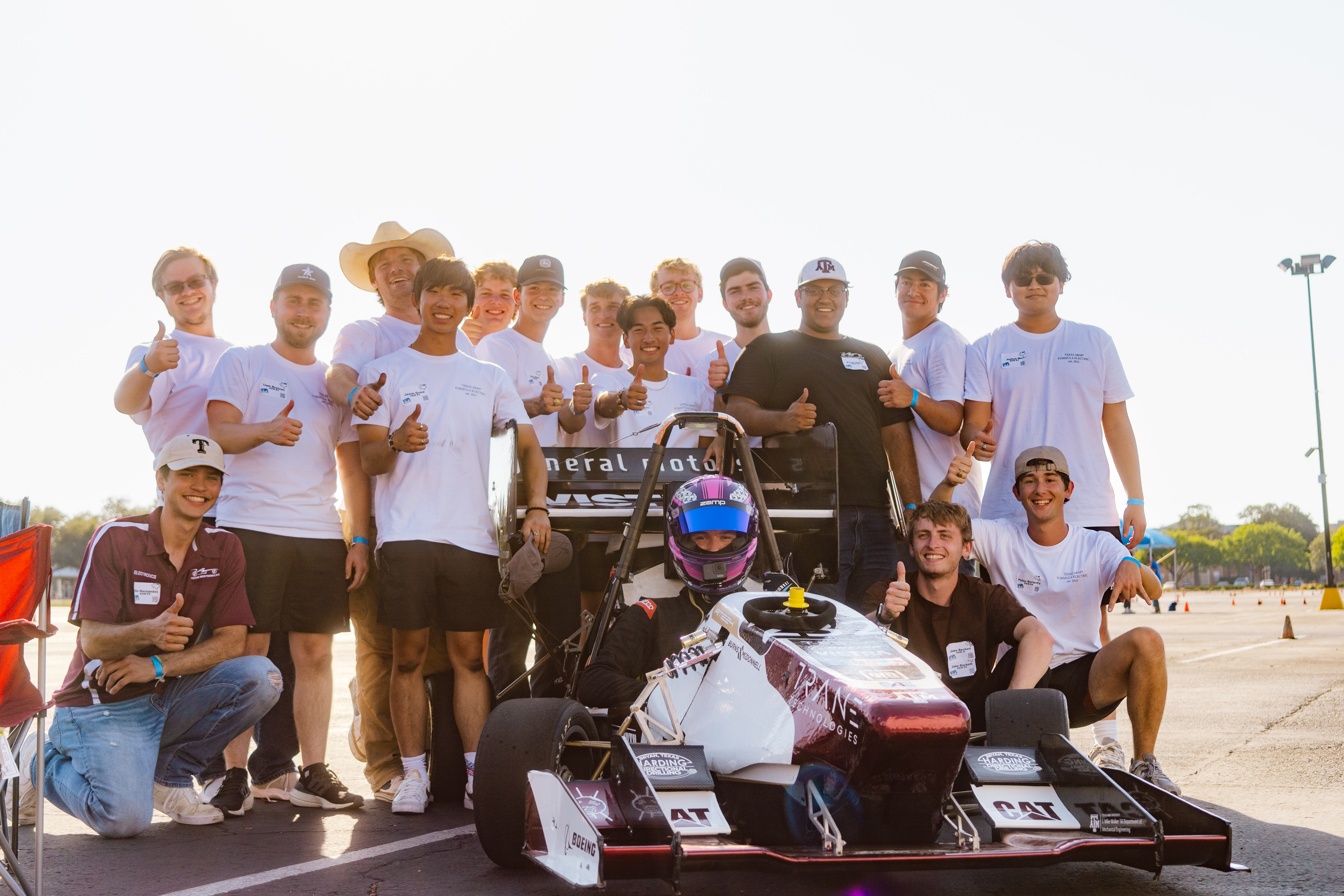 The Formula Electric team posing with the car at UTA Autocross in 2024