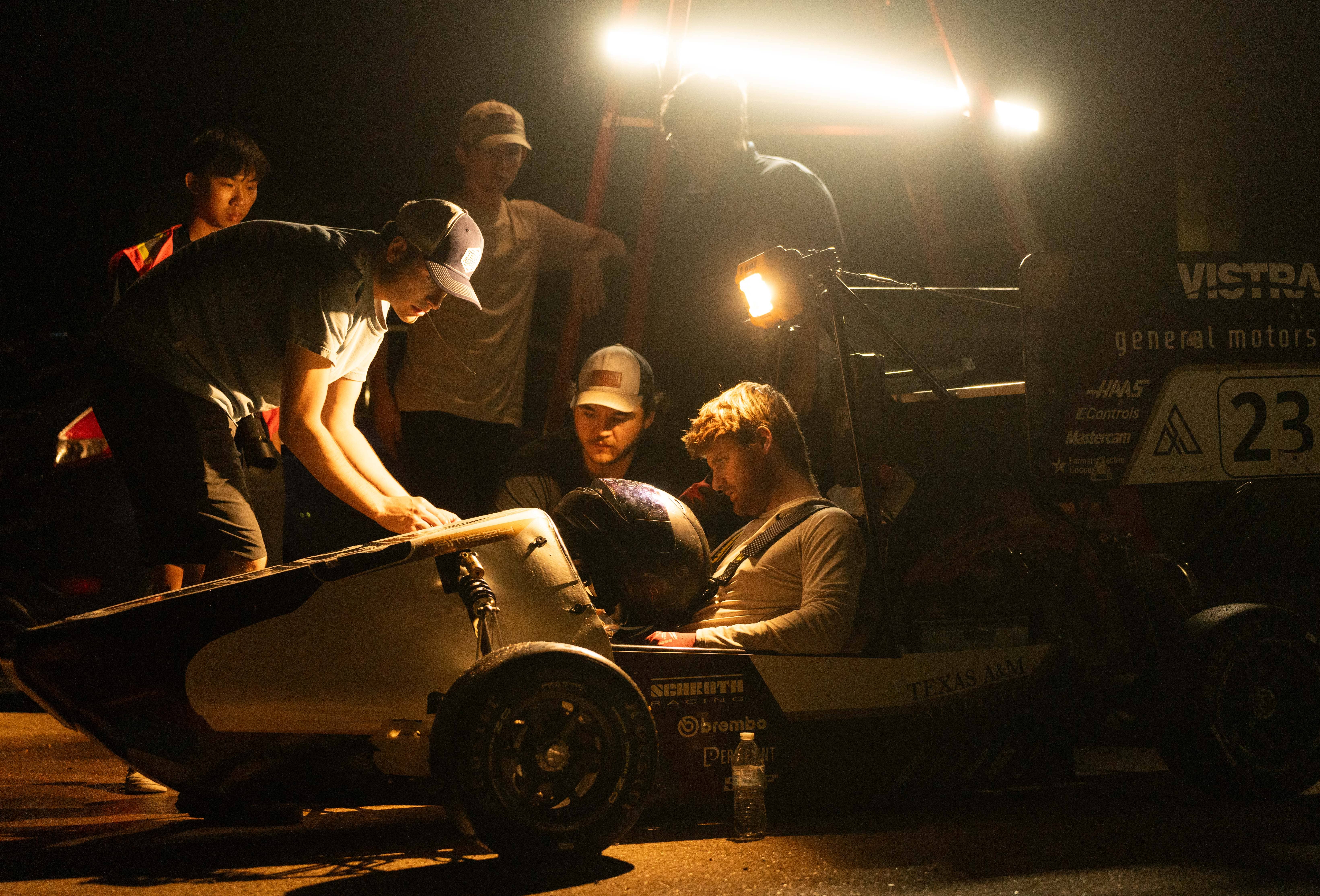 A low-angle shot of the AME24 car at night with dramatic lighting.